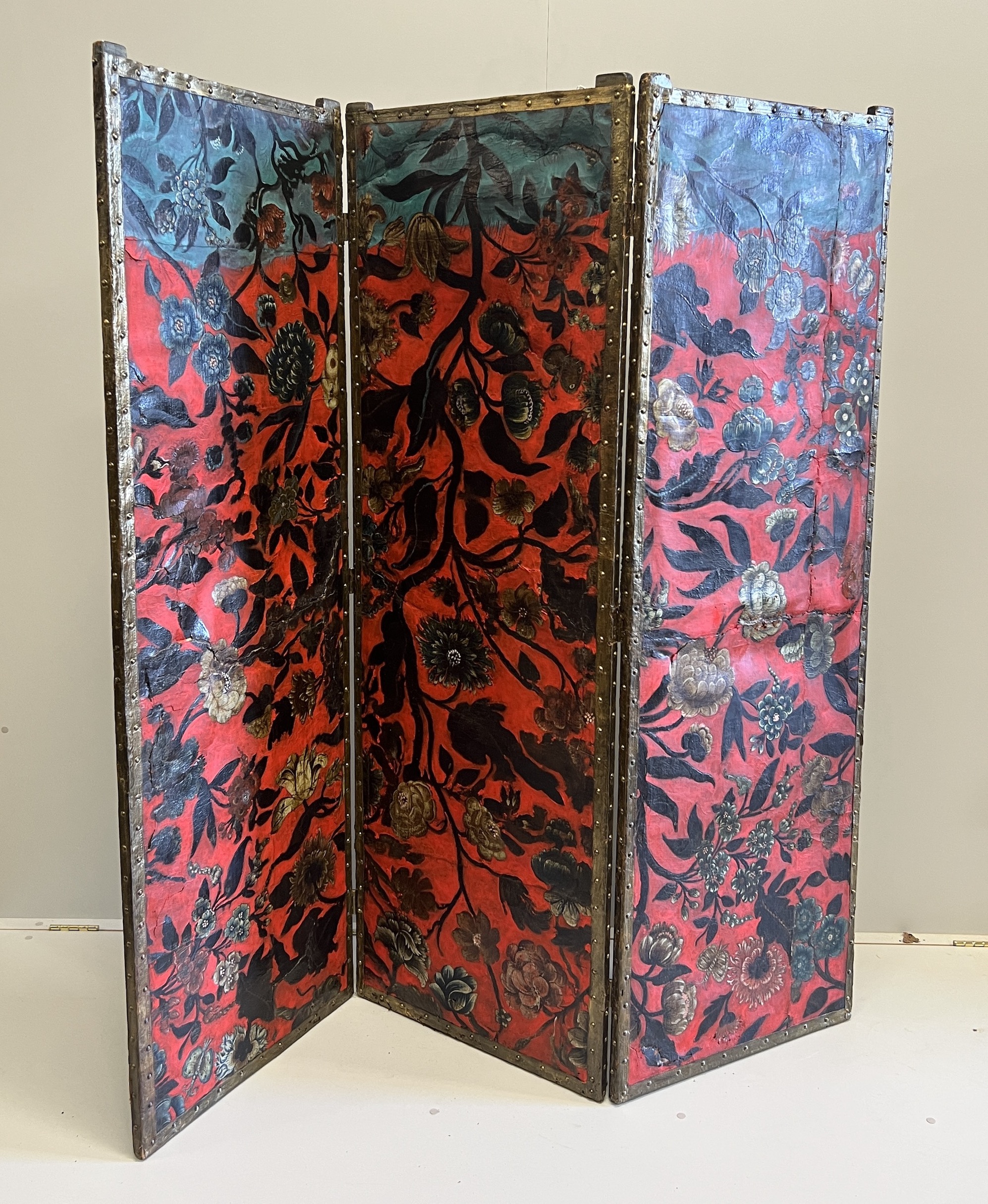 A 19th century Spanish leather three fold dressing screen re-painted by Ricardo Cinalli for the current owner, each panel width 57cm, height 175cm